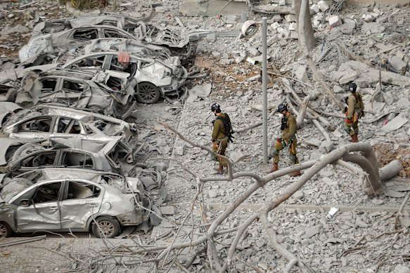 Emergency responders work at a building where at least four people died in a missile strike on June 24 in Beersheba, Israel. 