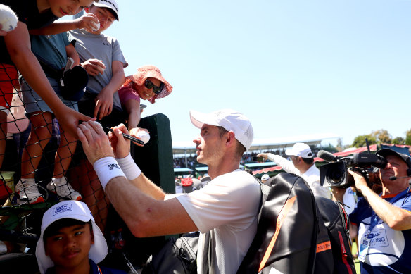 Andy Murray of Great Britain signs autographs for supporters on Wednesday at Kooyong.