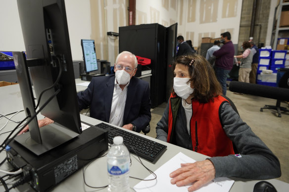 Democratic and Republican representatives review absentee ballots in Georgia's Fulton County.