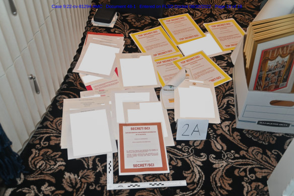 Contained in a court filing by the Justice Department and redacted in part by the FBI, this photo shows documents seized during the August search of Donald Trump’s Mar-a-Lago estate.