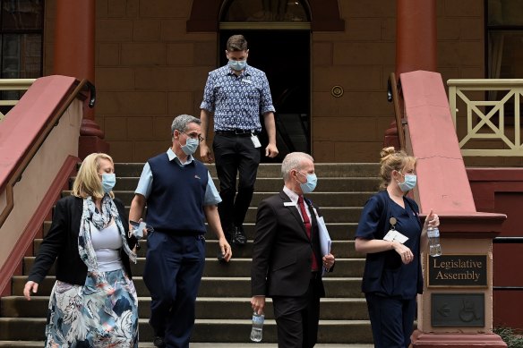 Some members of NSW Health leave NSW Parliament House which has been suspended after NSW Agriculture Minister Adam Marshall tested positive for COVID-19.