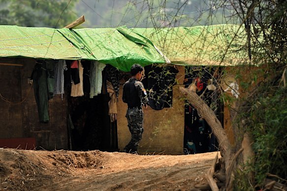 A soldier for the Democratic Karen Buddhist Army on duty near the River Moei in Taichang, also known as Mountain View, a development where scam centres operate.