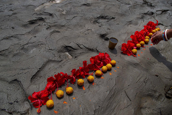 A Hindu woman performs rituals during a prayer ceremony to rid the world of coronavirus, on the banks of the river Brahmaputra in Gauhati, India.