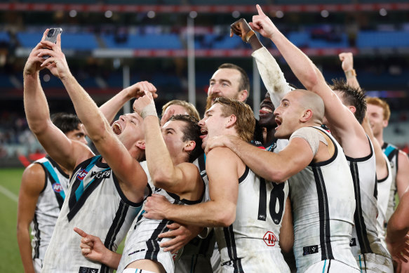 Dan Houston takes a selfie amid the Port celebrations after kicking a season-defining goal after the siren to beat Essendon.