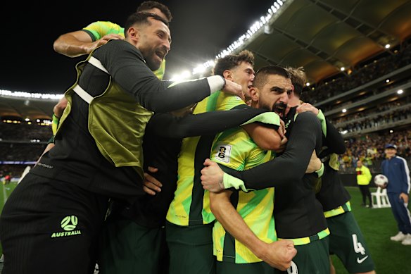 Aziz Behich and the Socceroos celebrate direct World Cup qualification.
