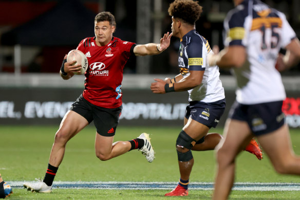 David Havili of the Crusaders puts the fend on  Rob Valetini of the Brumbies.