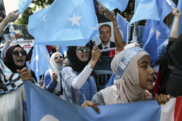 Uighurs with separatist flags of East Turkestan protest outside the Chinese consulate in Istanbul in July.