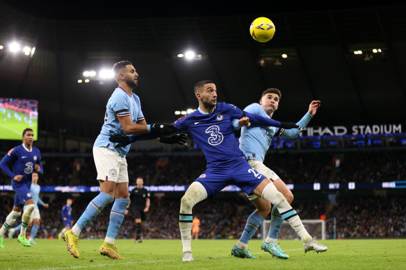 City’s Julian Alvarez and Kyle Walker jostle with Hakim Ziyech.