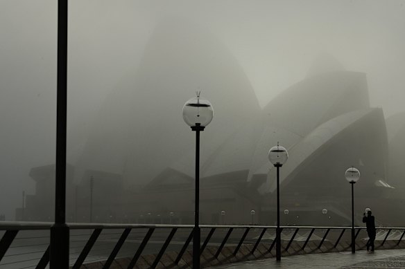 The Sydney Opera House surrounded by fog.