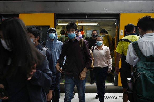 Commuters disembark from a train at Parramatta Station on Tuesday.