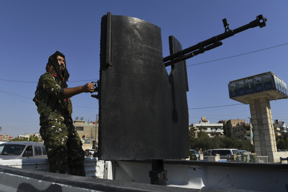 Raman Qamishlo mans a heavy weapon patrolling the streets of Qamishli.