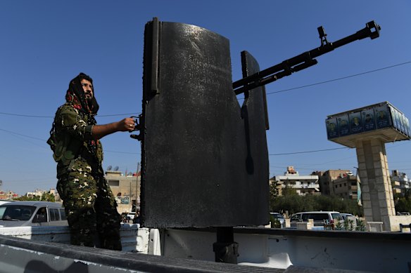 Raman Qamishlo mans a heavy weapon patrolling the streets of Qamishli.