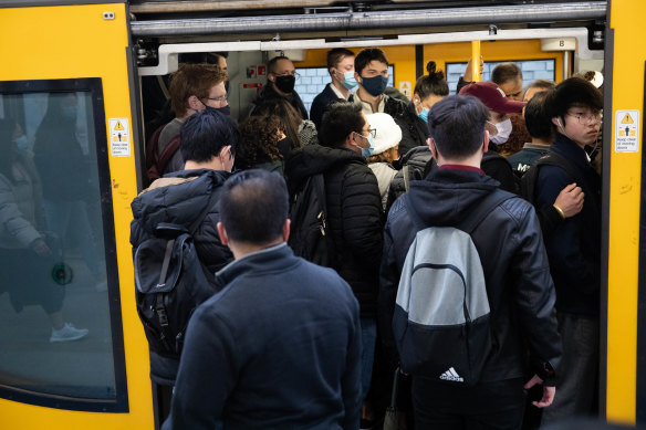 Crowds gather at Central Station as trains run on a reduced timetable.