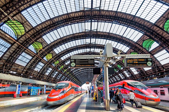 Modern high-speed trains await passengers inside Milan’s cavernous central station.