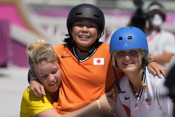 Misugu Okamoto is carried off by Poppy Olsen and Bryce Wettstein after a fall in her run.