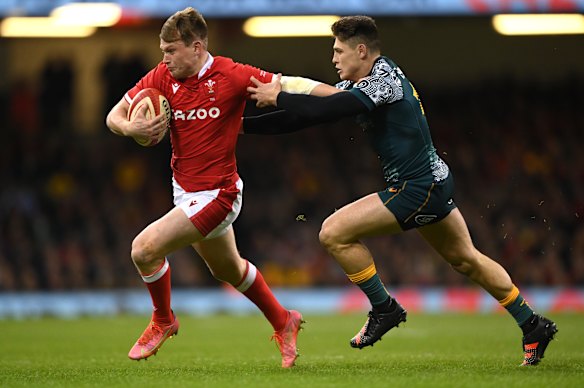 Wallabies fly half James O’ Connor is shrugged off by Wales centre Nick Tompkins.