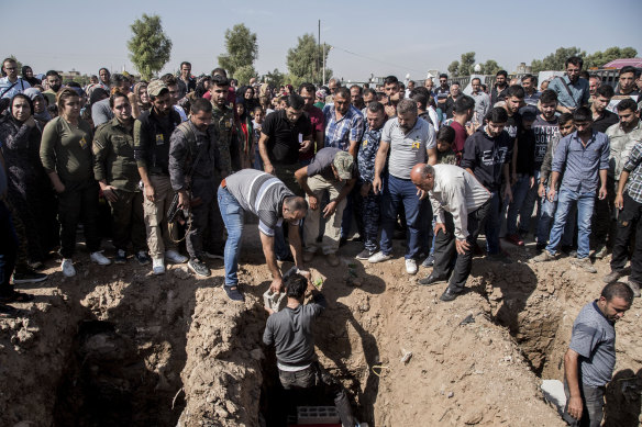 People attend funerals of fighters of the Syrian Democratic Forces killed fighting the Turkish advance, in the town of Qamishli, northern Syria, on Wednesday.
