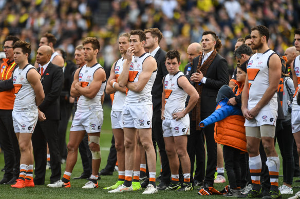 The Giants watch on as the Tigers celebrate during the post-match presentation.