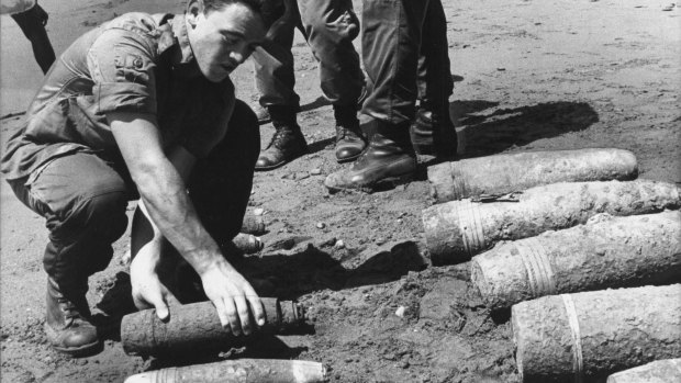 The Australian 1st Field Engineer Regiment stack live World War II artillery shells on a Solomon Islands beach. The soldiers had been dispatched on an aid project and after clearing a 10-hectare site, the shells were dumped at sea.