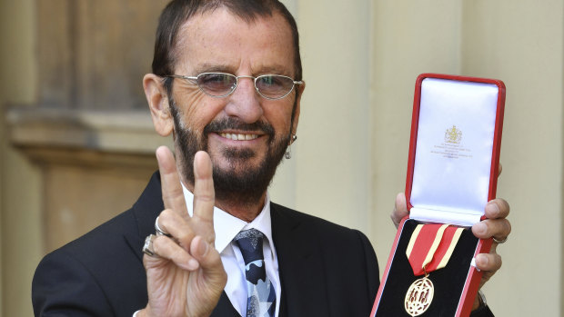 Musician Ringo Starr poses for photographers after being awarded a knighthood.
