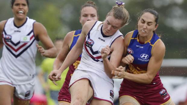 Fremantle's Hayley Miller is bumped by Sharni Webb of the Lions.