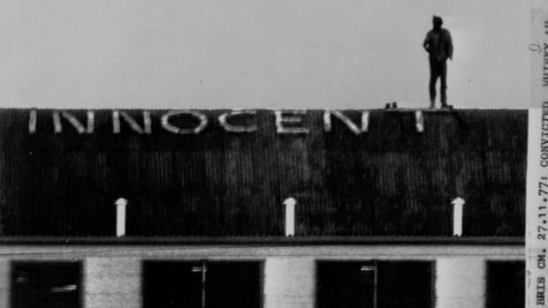Convicted Whiskey Au Go Go murderer John Andrew Stuart on top of a cell block at Boggo Road where he spelled out 'innocent'.