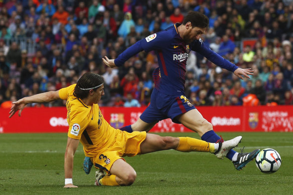 Lionel Messi (right) duels with Atletico's Filipe Luis for the ball.