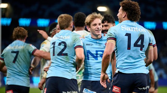 Max Jorgensen (centre) and Mark Nawaqanitawase (No.14) celebrate the latter’s try on Saturday night.