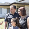 Premier Gladys Berejiklian talks solar power to Casula residents Adam and Leanne Gaudry with daughter Mia ,8, while Treasurer Dominic Perrottet talks to son Liam, 4.