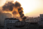 Smoke is seen from a collapsed building after it was hit by Israeli airstrikes on Gaza City.