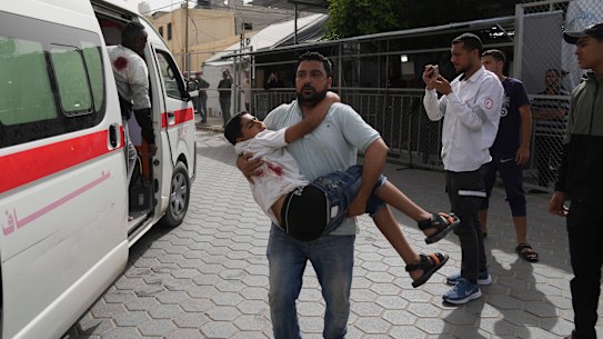 A Palestinian youth injured in an Israeli airstrike is brought to Al-Aqsa Hospital.