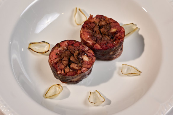 Whole oxtail is braised in bourbon, the meat pulled off and re-formed. 