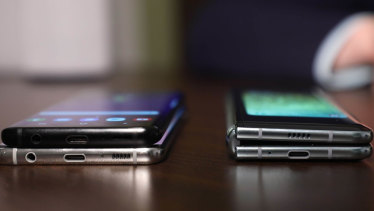 The Samsung Galaxy Fold, right, is about as thick as two smartphones stacked on top of each other.
