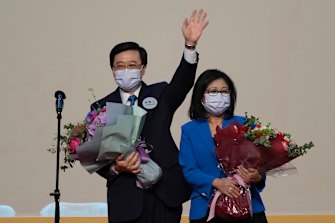 John Lee, former No. 2 official in Hong Kong and the only candidate for the city’s top job, celebrates with his wife after declaring his victory in the chief executive election of Hong Kong on Sunday.