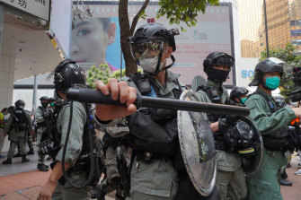 Riot police form a line as they plan to clear away people gathered in the Central district in Hong Kong last week.