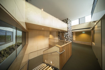 A double-height void in the reception area alludes to the spaces found in the buildings either side.