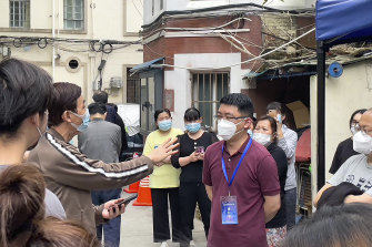 Residents confront a representative about opening up of their compound in Jingan district in Shanghai.