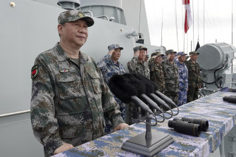 Chinese President Xi Jinping, left, reviews a Navy fleet in the South China Sea after announcing live-fire drills in the Taiwan Straight in 2018. 