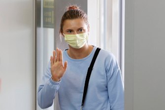 Belarusian Olympic sprinter Krystsina Tsimanouskaya waves as she leaves Narita International Airport on Wednesday.