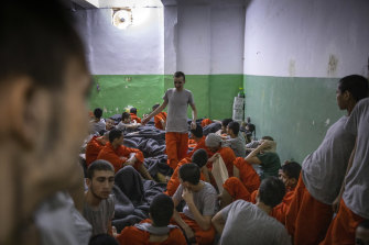  Young boys, many under the age of 16, sit in a crowded cell at a prison for former Islamic State members run by Kurdish-led forces in Hasaka, in northeast Syria in 2019. 
