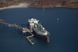 A ship carrier that is designed for transporting liquefied natural gas (LNG) is moored at the purpose built jetty at The Burrup Park LNG Plant on the Burrup Peninsula, Western Australia.