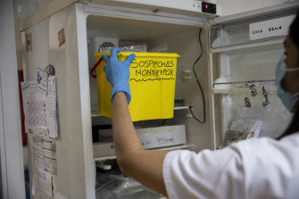 A technician takes a bucket with suspected monkeypox samples to be tested at the microbiology laboratory of La Paz Hospital in Madrid, Spain.