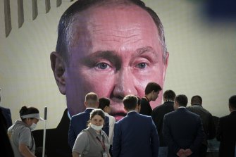 Participants watch Russian President Vladimir Putin’s addressing a plenary session of the St Petersburg International Economic Forum.