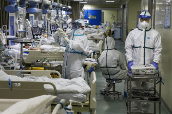 Medical workers treat patients in the isolated intensive care unit at a hospital in Wuhan in February 2020. 
