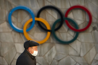 A man walks past the Olympic rings on the exterior of Beijing’s National Stadium, which will be a venue for the Winter Olympics.
