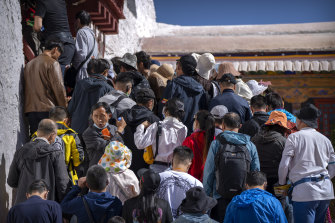 Tourists wait to climb steps to an indoor area in the Potala Palace in Lhasa.