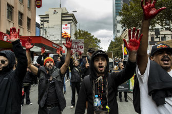 Protesters march in Melbourne  on Saturday over Indigenous deaths in custody. 