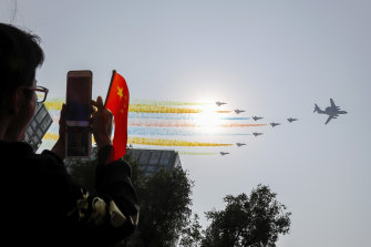 Chinese military planes fly in formation during a parade in Beijing to commemorate the 70th anniversary of the founding of communist China.