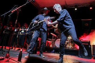 Peter Garrett and Martin Rotsey from Midnight Oil perform at an event to celebrate the closure of the Uluru climb.