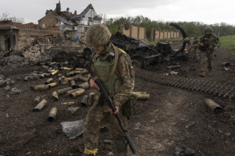 Ukrainian servicemen patrol in a recently retaken village, north of Kharkiv, east Ukraine, on Sunday. 
